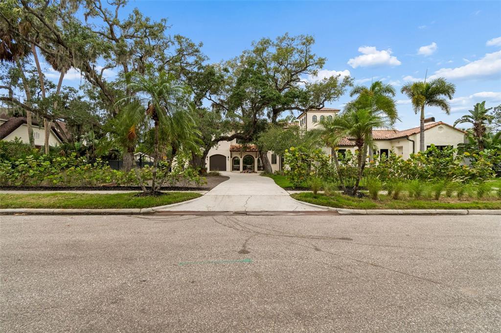 A two-story Mediterranean-style house with a red tile roof, white stucco walls, and palm trees — 2603 S PARKVIEW STREET, TAMPA, FL