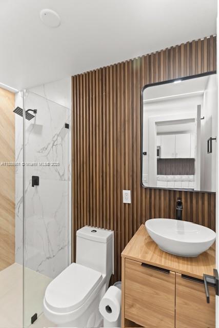 A modern bathroom features a glass-enclosed shower, a vessel sink, and wood-slat accent walls — 3125 NW 21st Ct # 02, Miami FL 33142, MIAMI, FL