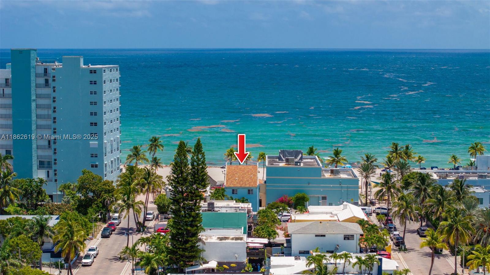 An aerial view shows a small building with a red tile roof near the ocean — 311 N Surf Rd # 311, Hollywood FL 33019, HOLLYWOOD, FL