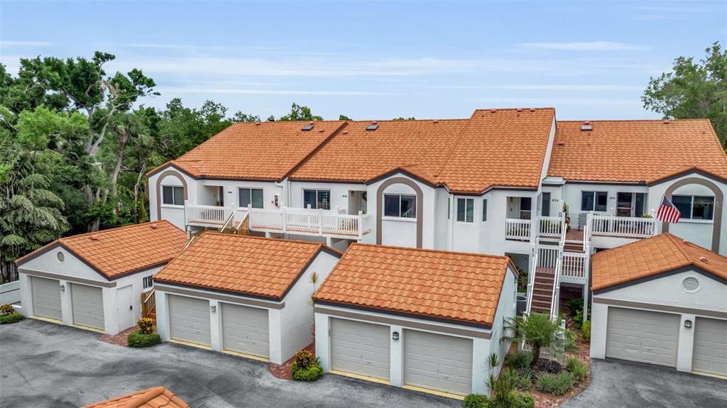 A small outdoor patio features a white table with three chairs on a brick floor — 862 HUDSON AVENUE UNIT 862, SARASOTA, FL