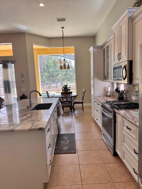 A single-story house with a tan stucco exterior, a tile roof, and a two-car garage — 9512 SERRA COURT, HOWEY IN THE HILLS, FL