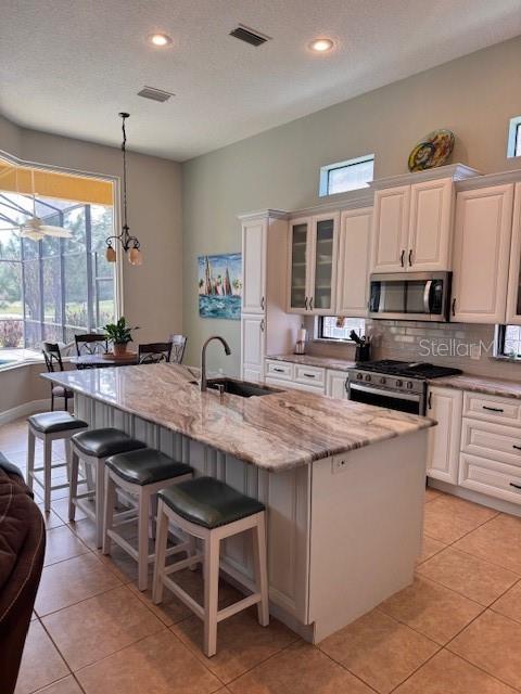 A single-story house with a tan stucco exterior, a tile roof, and a two-car garage — 9512 SERRA COURT, HOWEY IN THE HILLS, FL