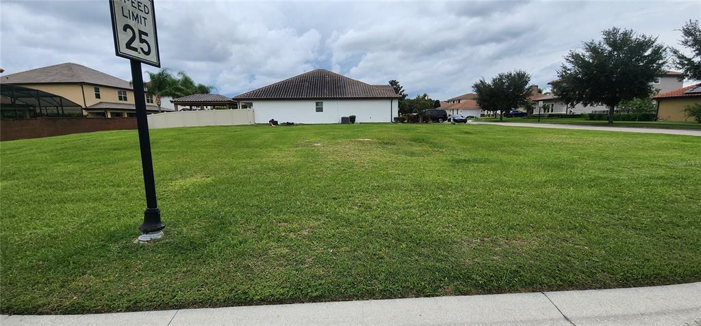 A vacant grassy lot is situated in a residential neighborhood next to a speed limit sign — 1198 BELLA VISTA CIR, LONGWOOD, FL