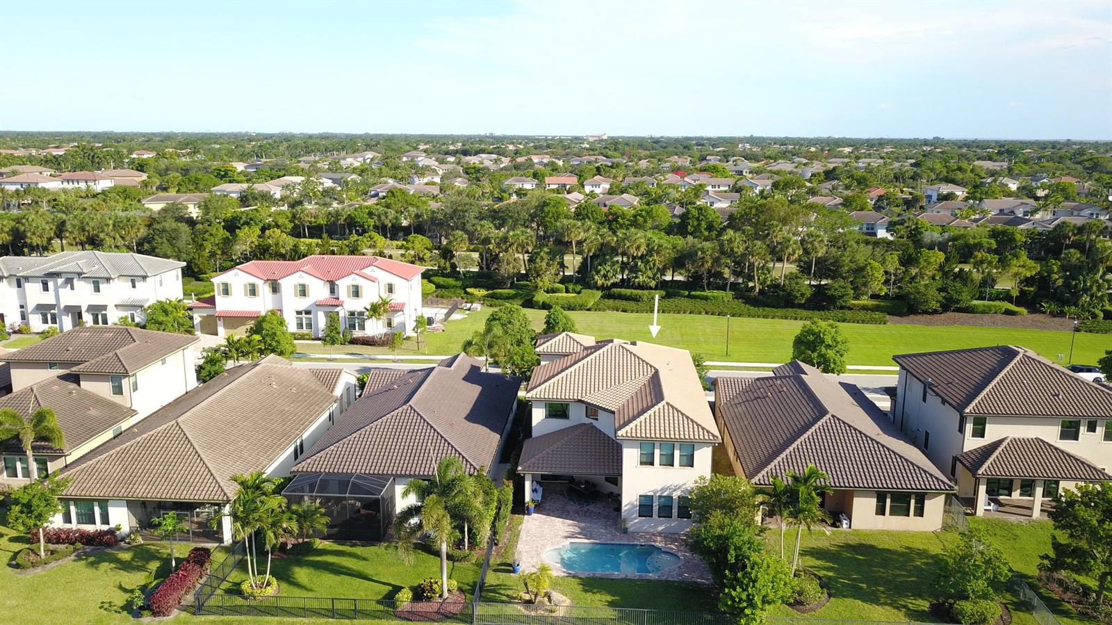 An aerial view shows a two-story house with a pool and a large grassy backyard — 11965 S Baypoint Circle, Parkland FL 33076, PARKLAND, FL