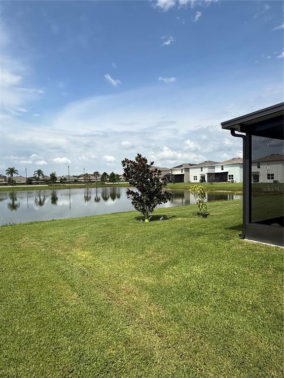 A two-story white house with a two-car garage and a palm tree in the yard — 15990 TUSCANY HILLSIDE ROAD, ODESSA, FL