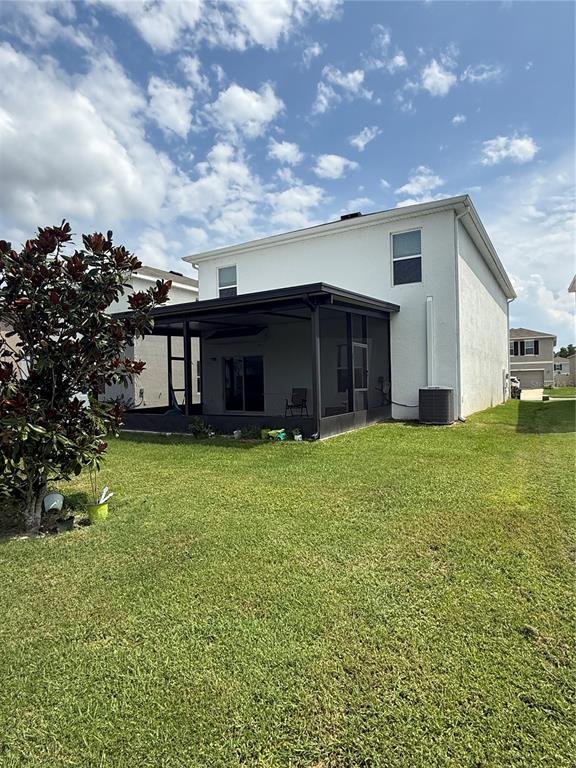 A white stucco house exterior features a dark front door, a garage, and a walkway — 15990 TUSCANY HILLSIDE ROAD, ODESSA, FL
