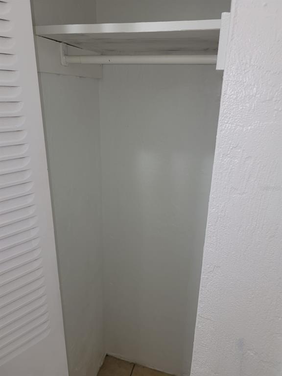 A white closet interior featuring a single upper shelf and a hanging rod — 1216 KENNEDY ROAD UNIT 8, DAYTONA BEACH, FL