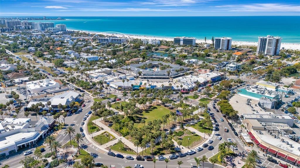 An aerial view shows a coastal town with a park, commercial buildings, and a beach — 350 S POLK DRIVE UNIT 302, SARASOTA, FL