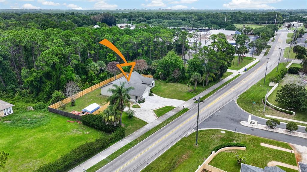 An aerial view shows a single-story house with a gray roof and a concrete driveway — 191 ROBERTS ROAD, EDGEWATER, FL