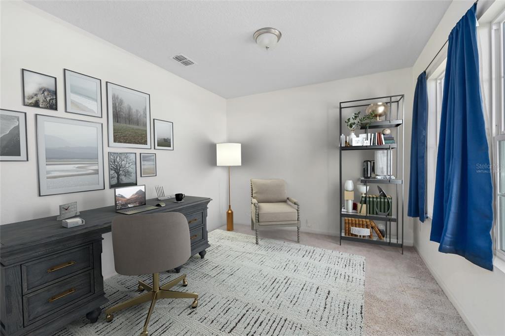 A home office features a dark wood desk, a beige armchair, and a metal bookshelf — 724 LIBERTY CIRCLE, MACCLENNY, FL