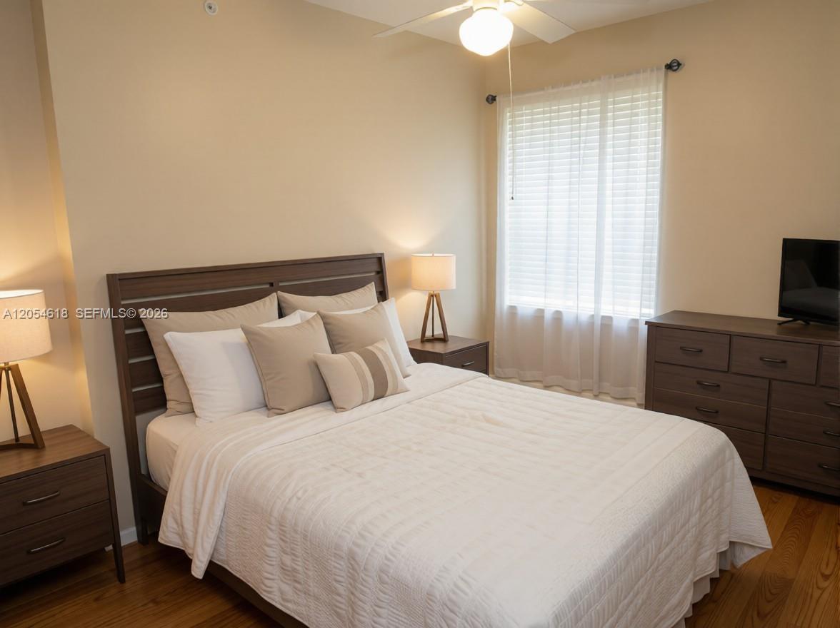 A bedroom features a wooden bed frame, matching nightstands, a dresser, and a window with blinds — 175 Galicia Way # 0, Jupiter FL 33458, JUPITER, FL