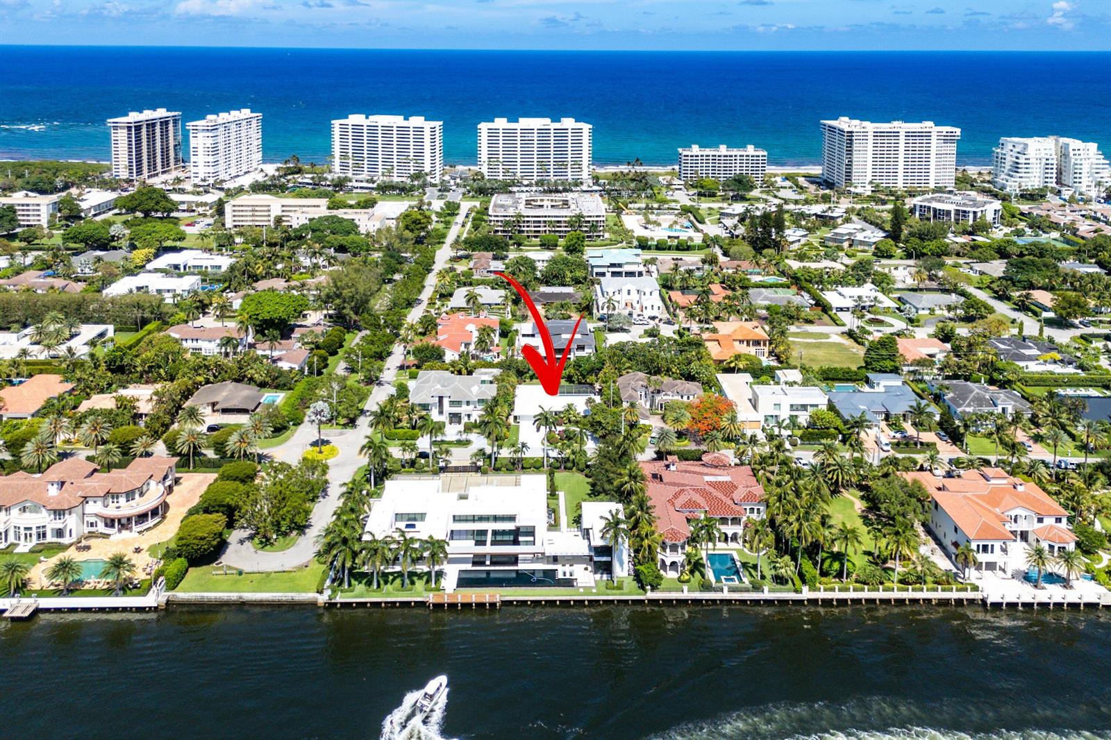 An aerial view of a waterfront neighborhood with a red arrow pointing to a house — 1350 Spanish River Road, Boca Raton FL 33432, BOCA RATON, FL