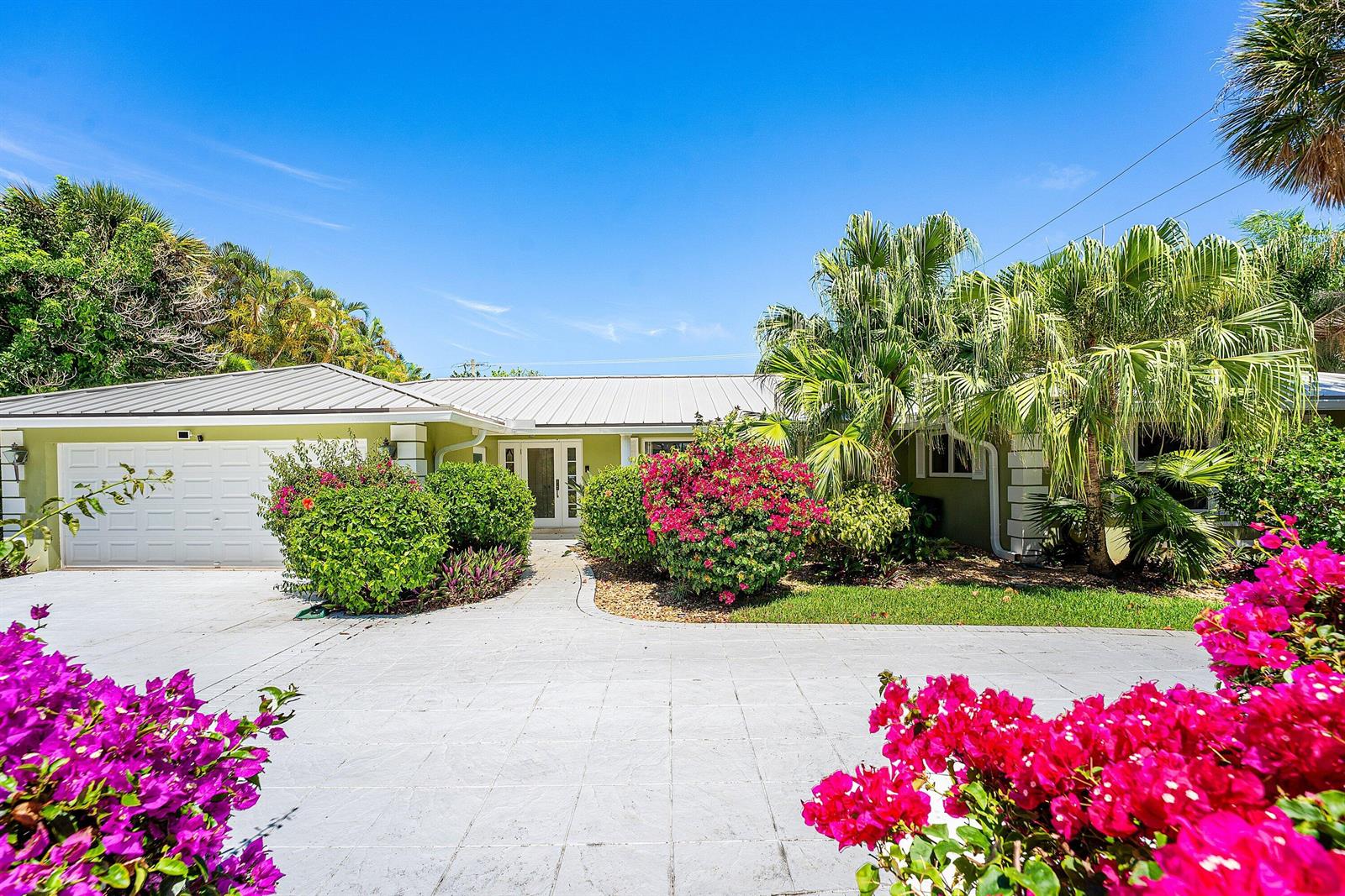 A single-story house with a white metal roof, green siding, and a paved driveway — 1350 Spanish River Road, Boca Raton FL 33432, BOCA RATON, FL