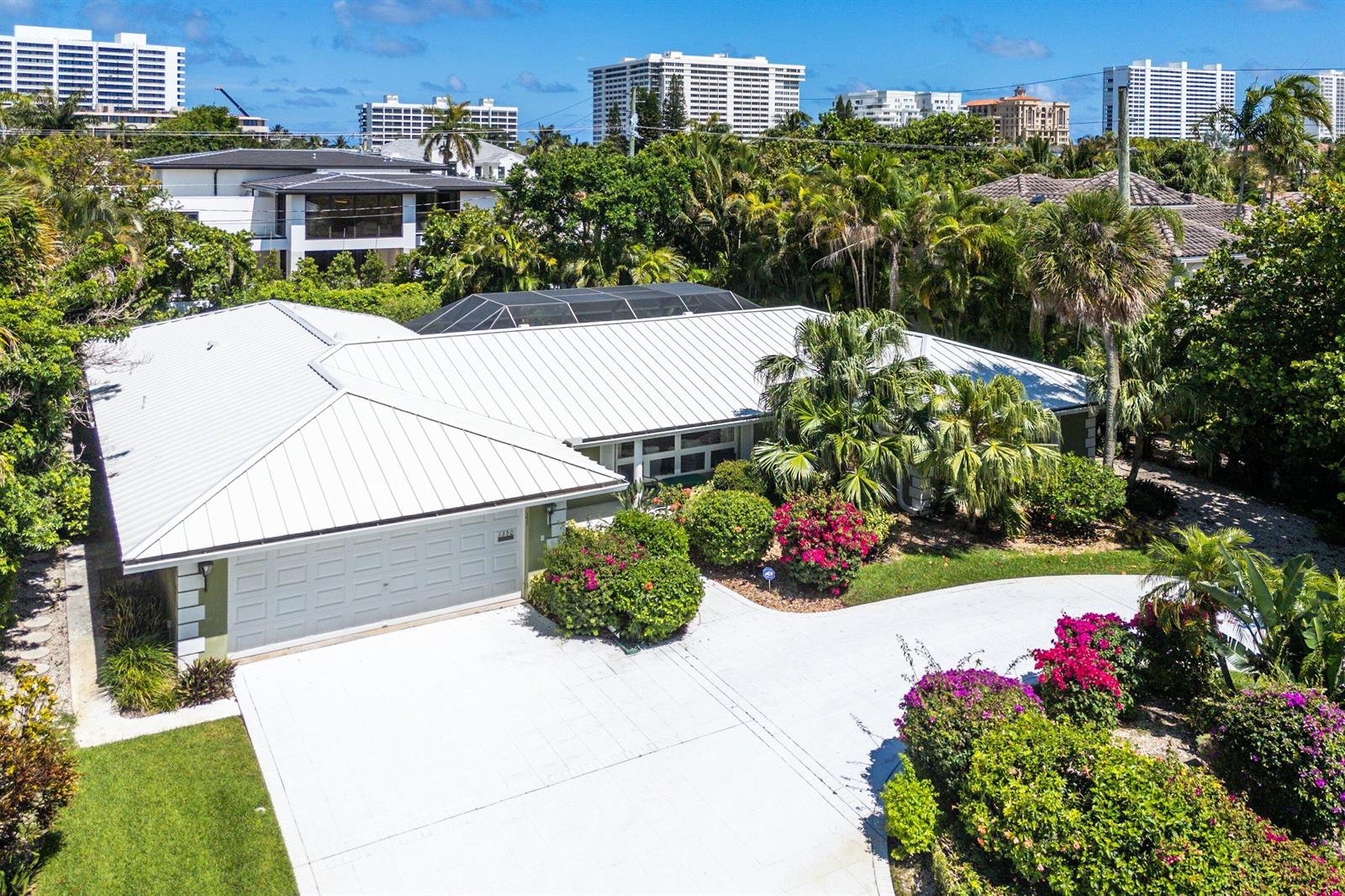An aerial view of a single-story house with a white metal roof and concrete driveway — 1350 Spanish River Road, Boca Raton FL 33432, BOCA RATON, FL