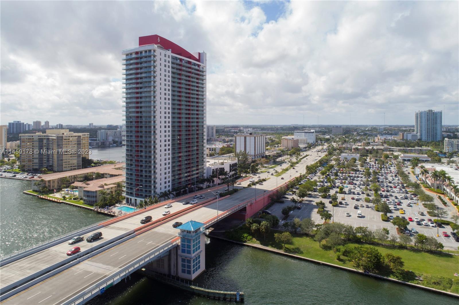 A modern living and dining area features a sectional sofa, round table, and floor-to-ceiling windows — 4010 S Ocean Dr # R2206, Hollywood FL 33019, HOLLYWOOD, FL