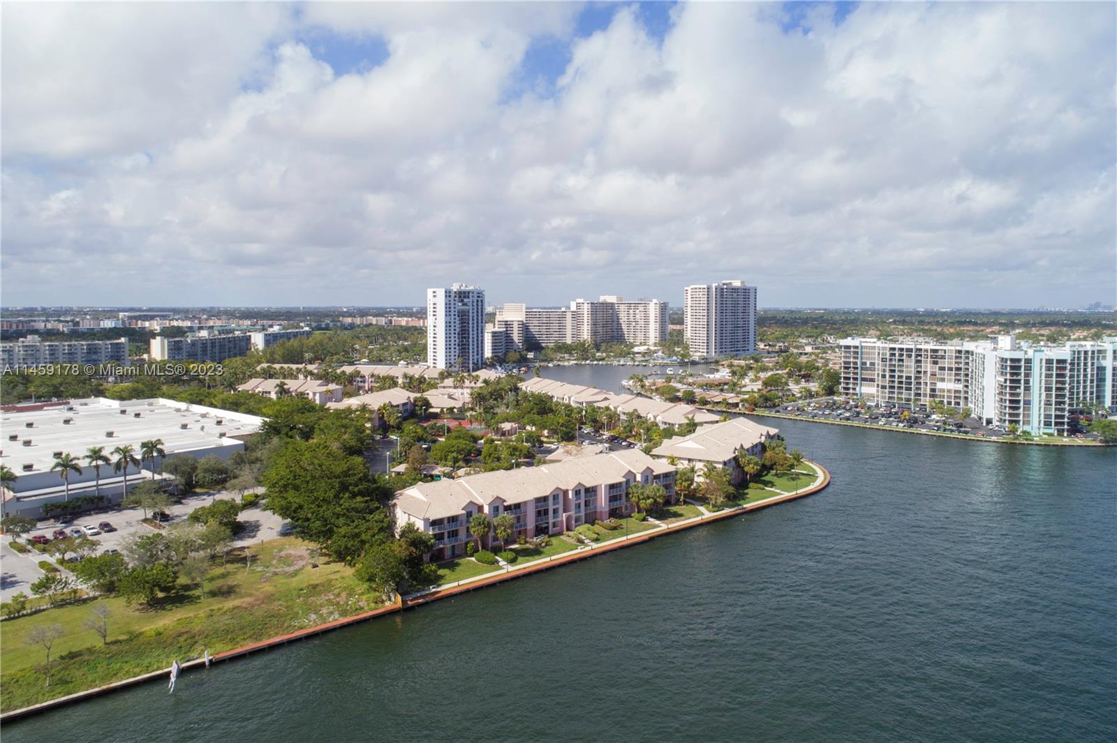 An aerial view shows a tall residential tower next to a bridge over water — 4010 S Ocean Dr # R2206, Hollywood FL 33019, HOLLYWOOD, FL