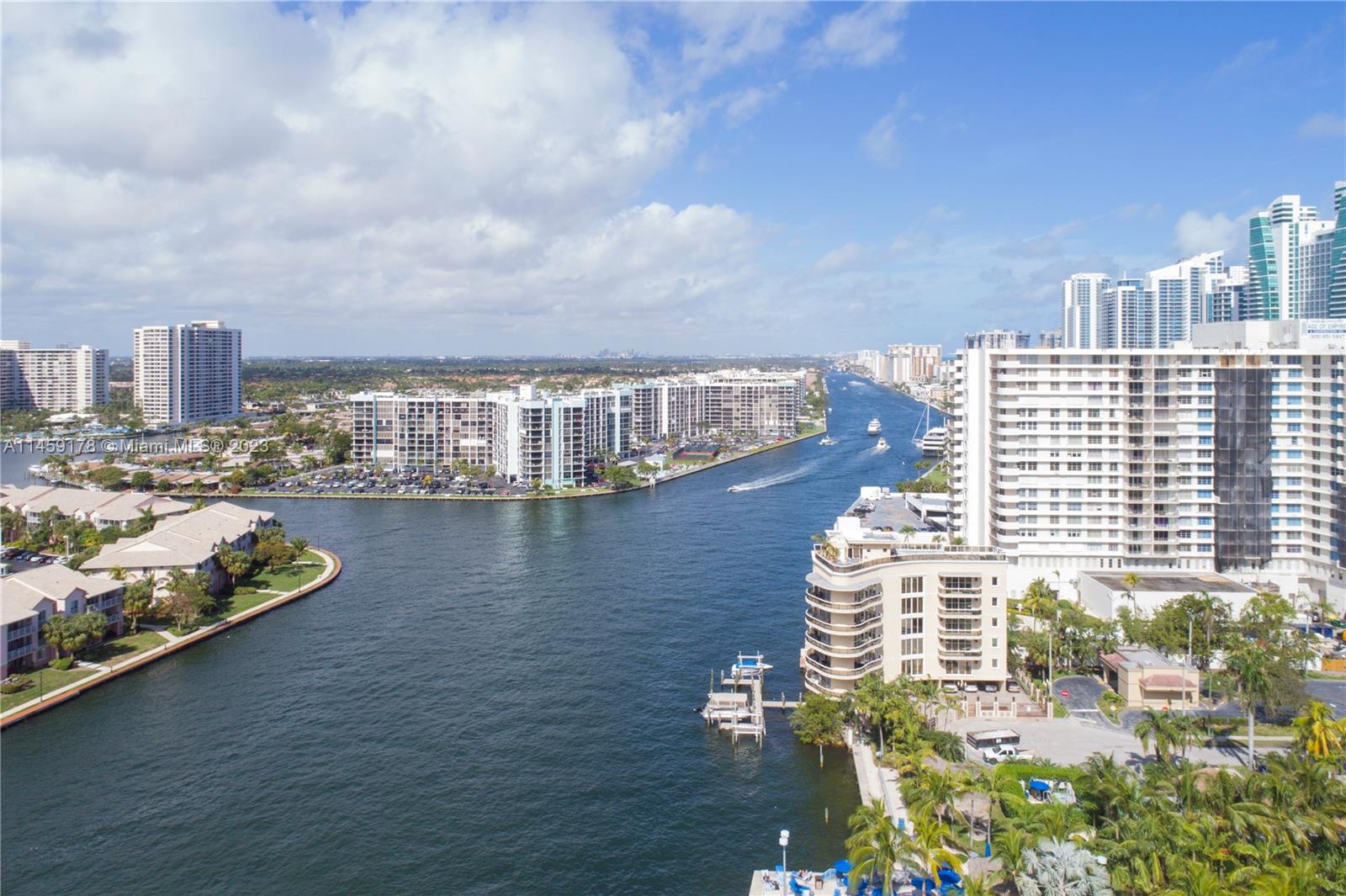 An aerial view shows a large parking lot, commercial buildings, and a waterfront area — 4010 S Ocean Dr # R2206, Hollywood FL 33019, HOLLYWOOD, FL