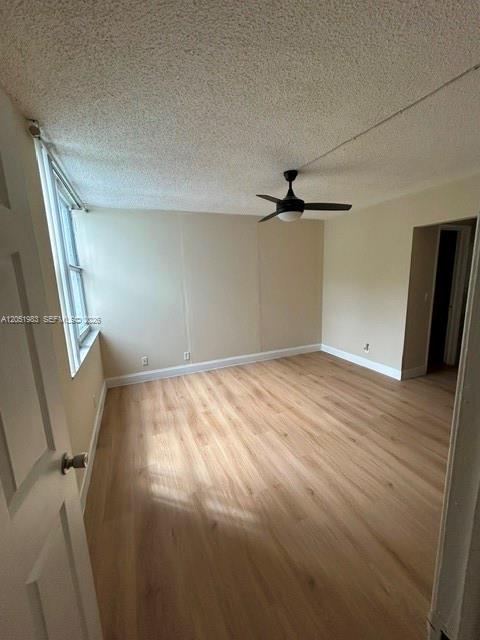 An empty room with light wood-look flooring, a ceiling fan, and a window — 9461 Evergreen Pl # 303, Davie FL 33324, DAVIE, FL