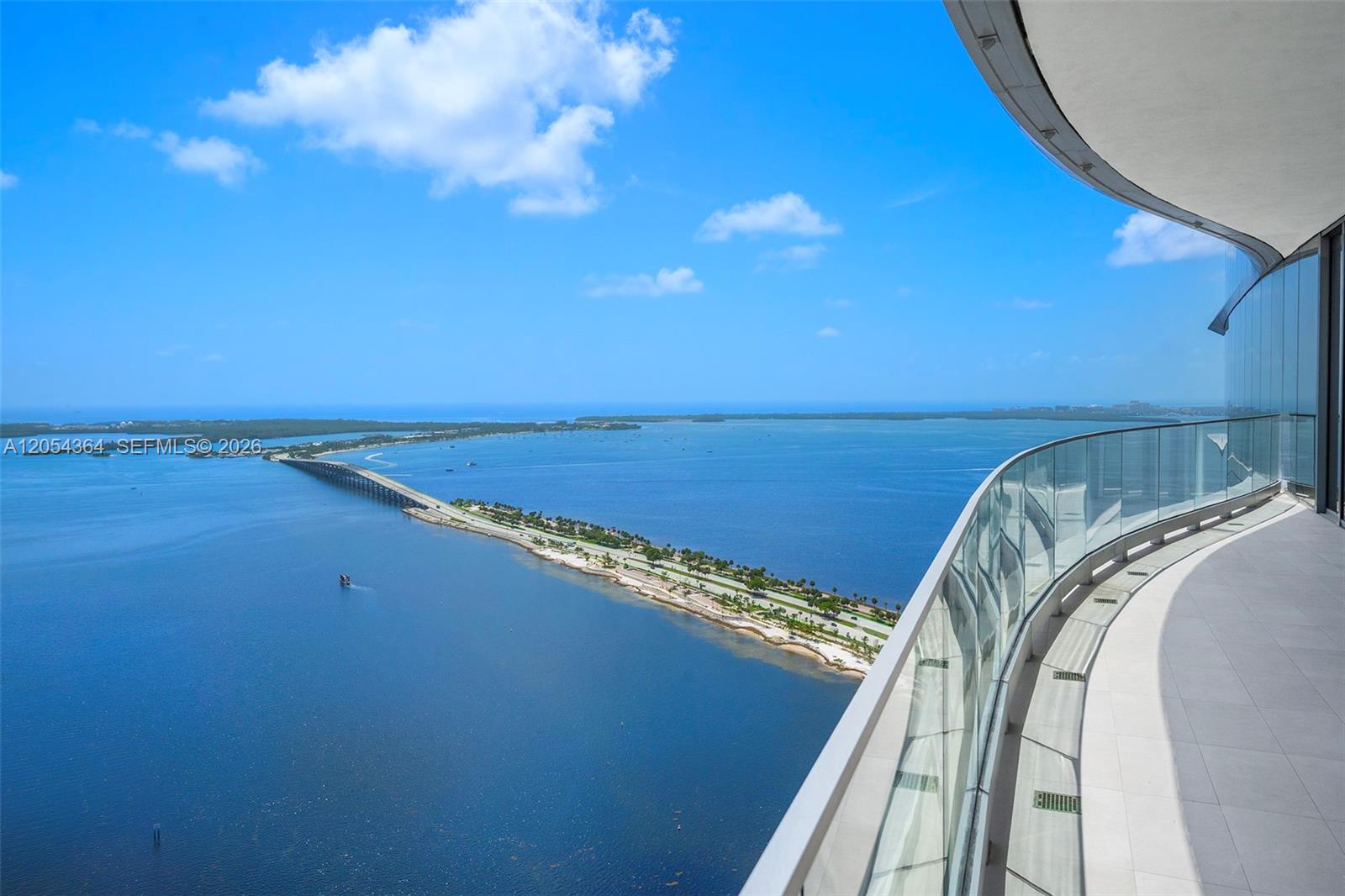 A high-rise balcony with a glass railing overlooks a long bridge spanning the water — 175 SE 25th Rd # 4001, Miami FL 33129, MIAMI, FL