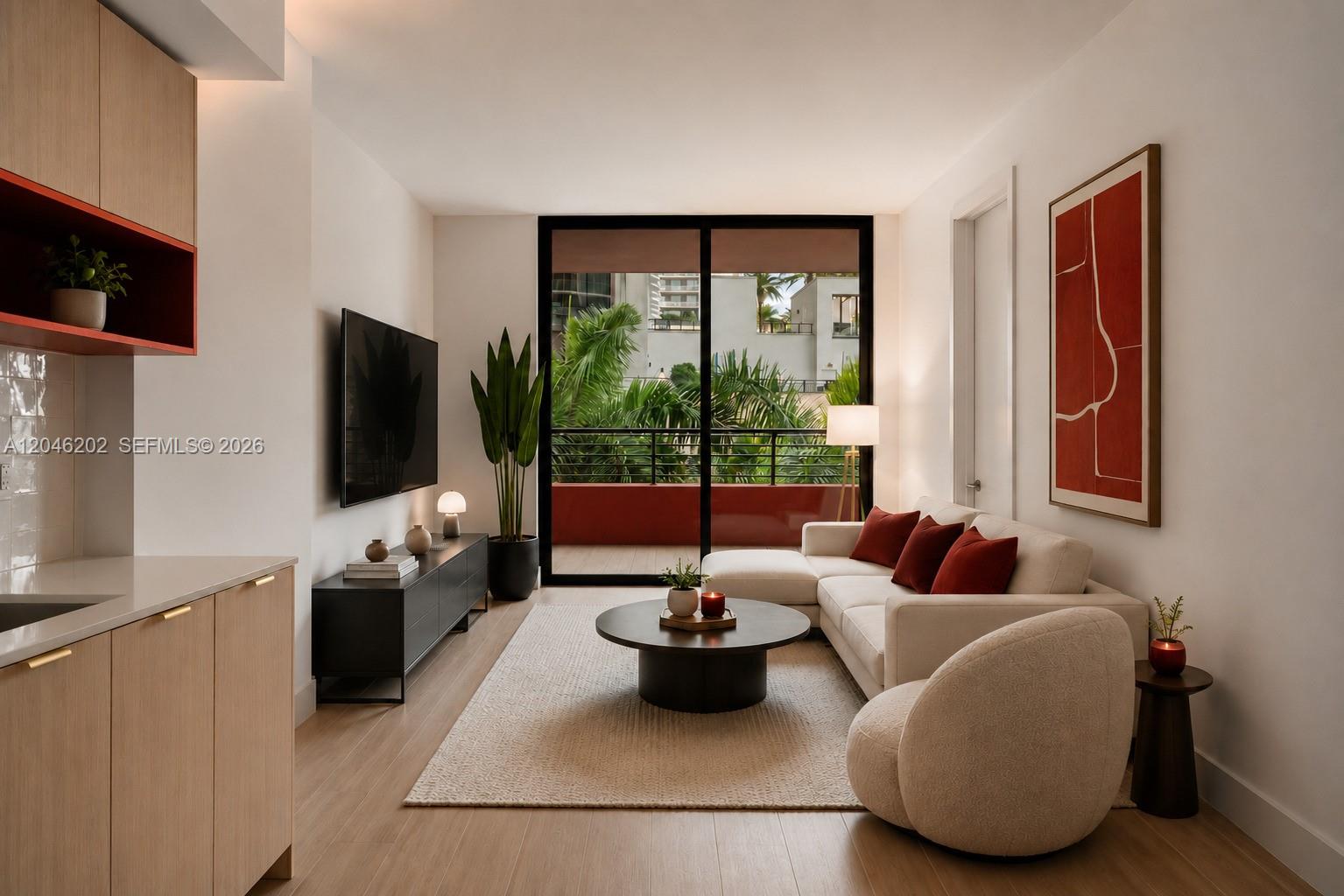 This modern living room features a white sectional sofa, a round coffee table, and balcony views — 90 NE 32nd # 404, Miami FL 33127, MIAMI, FL