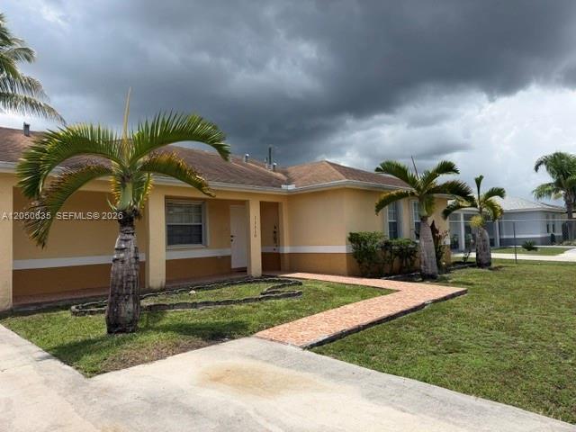 A single-story house with a tan exterior, a tiled walkway, and several palm trees — 11310 Booker T Washington, Miami FL 33176, MIAMI, FL