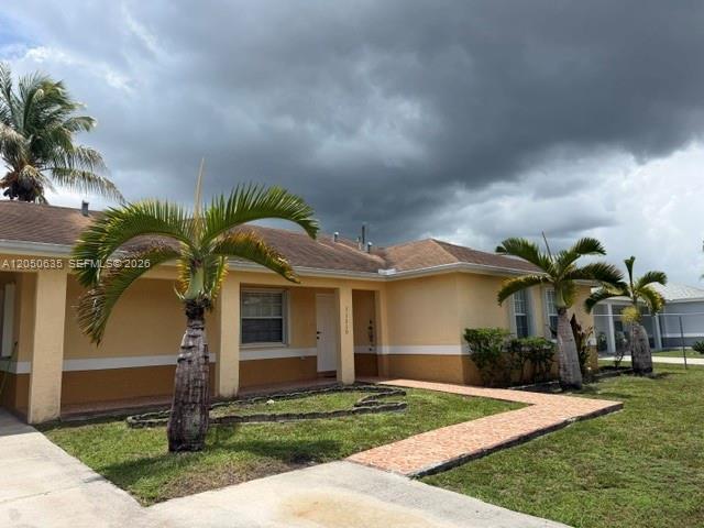 A single-story house with tan stucco walls and palm trees under a cloudy sky — 11310 Booker T Washington, Miami FL 33176, MIAMI, FL