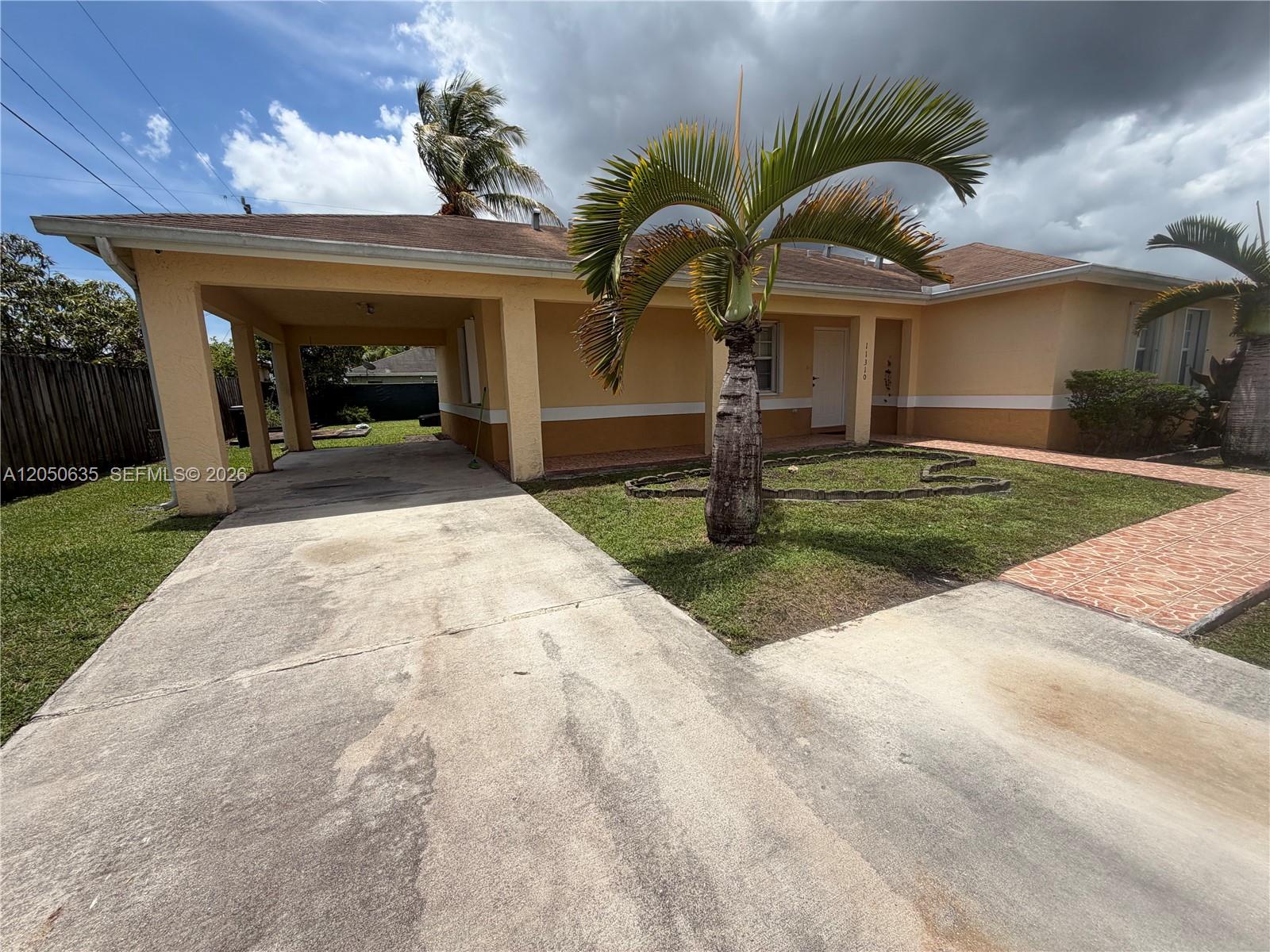 A single-story house with a carport, a palm tree, and a concrete driveway — 11310 Booker T Washington, Miami FL 33176, MIAMI, FL