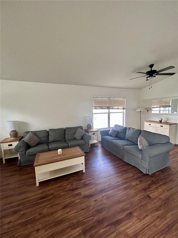 A living room features two blue sofas, a wooden coffee table, and wood-look flooring — 1061 PORTMOOR WAY, WINTER GARDEN, FL