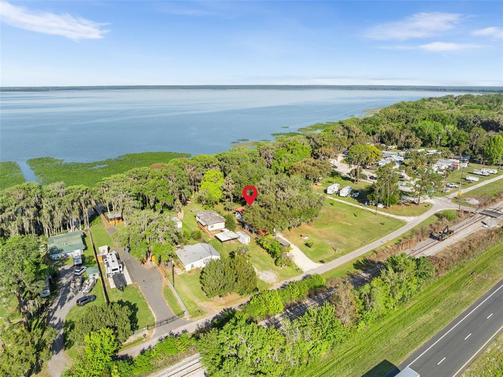 An aerial view shows a house with a red marker near a large lake — 15026 SE US HIGHWAY 301, HAWTHORNE, FL