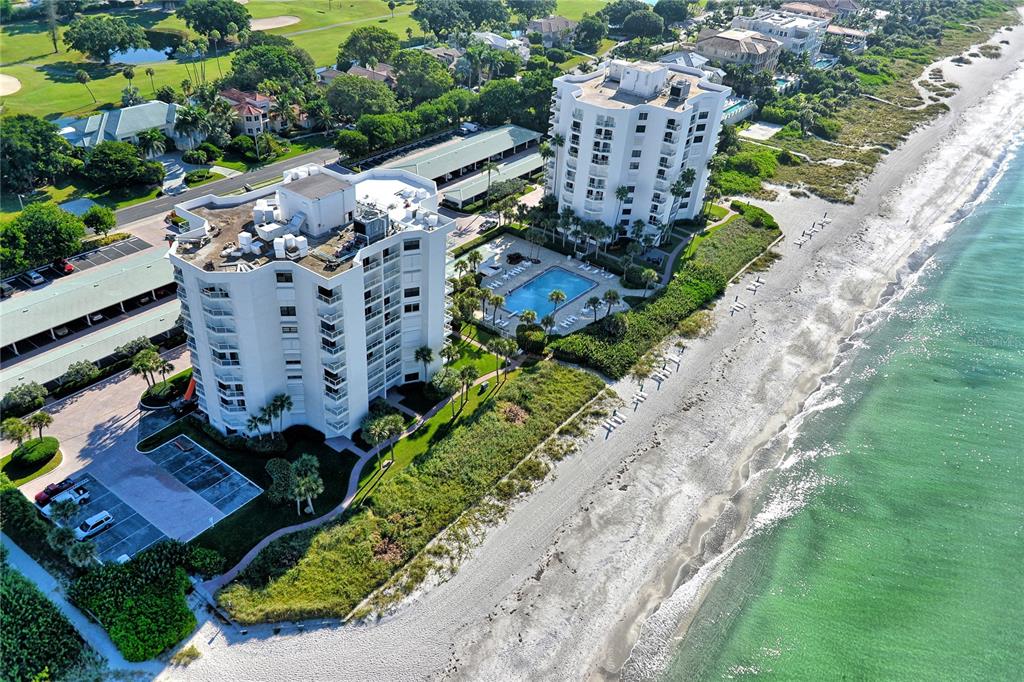 Aerial view of two beachfront condominium buildings with a pool and parking lots — 1000 LONGBOAT CLUB ROAD UNIT 403, LONGBOAT KEY, FL