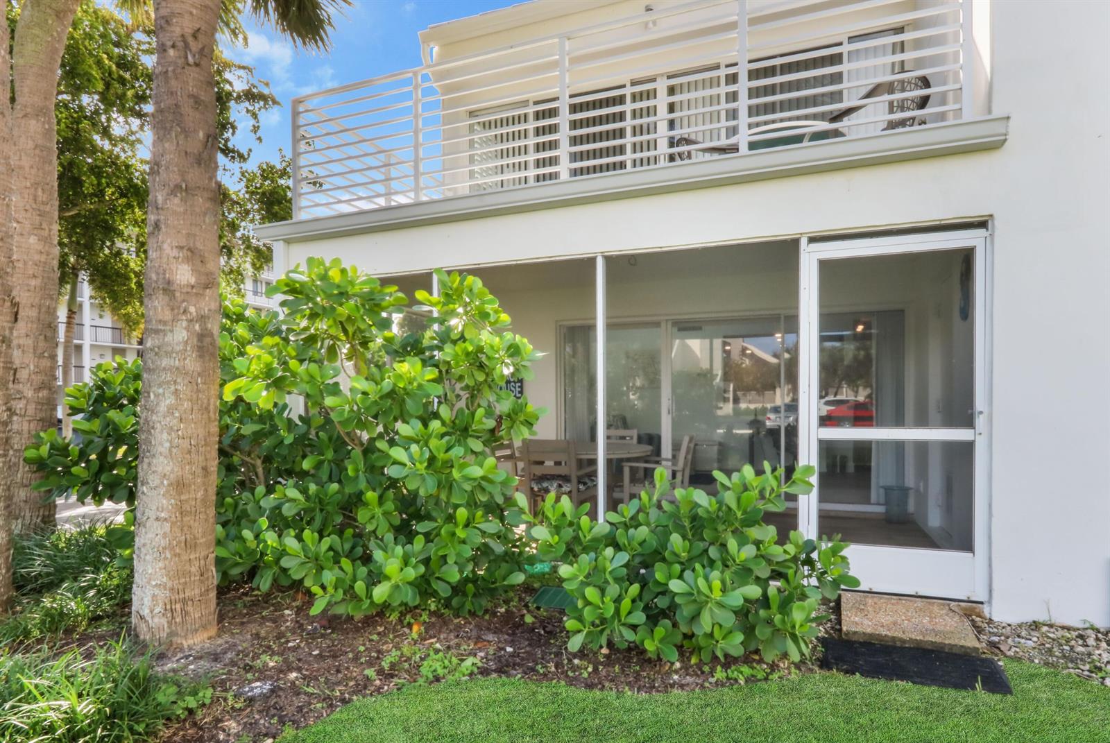 A two-story white building features a ground-level screened porch and an upper-level balcony — 1605 S Us Hwy 1, Jupiter FL 33477, JUPITER, FL