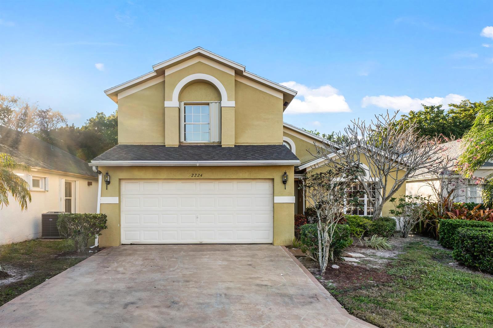 A two-story house with a yellow stucco exterior and a two-car garage — 2224 Soundings Court, FL 33413, FL