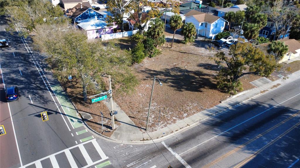 An aerial view shows a vacant corner lot with trees next to a paved road — 2762 1ST AVENUE S, ST PETERSBURG, FL