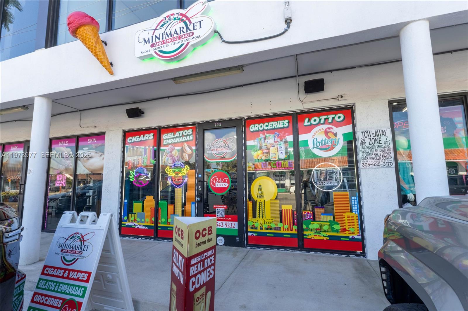 The exterior of a 24/7 minimarket and smoke shop features glass storefront doors and signage — 700 SW 17th Ave, Miami FL 33135, MIAMI, FL