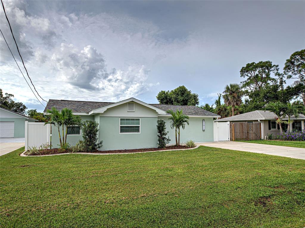 A light green single-story house with a shingled roof and a front lawn — 425 YALE STREET, ENGLEWOOD, FL