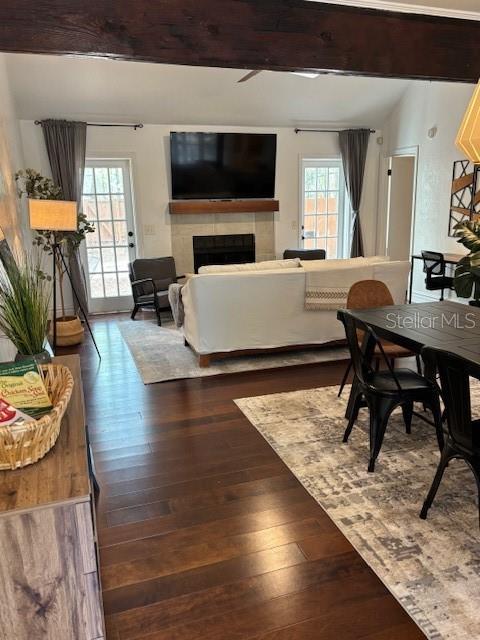 A living room with a fireplace, television, white sofa, and dark wood flooring — 5319 SW 88TH COURT, GAINESVILLE, FL