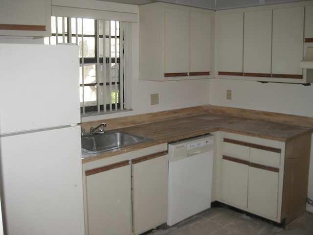 A kitchen features white cabinets, a laminate countertop, a stainless steel sink, and white appliances — 3665 NW 94th Avenue # 3j, Sunrise FL 33351, SUNRISE, FL