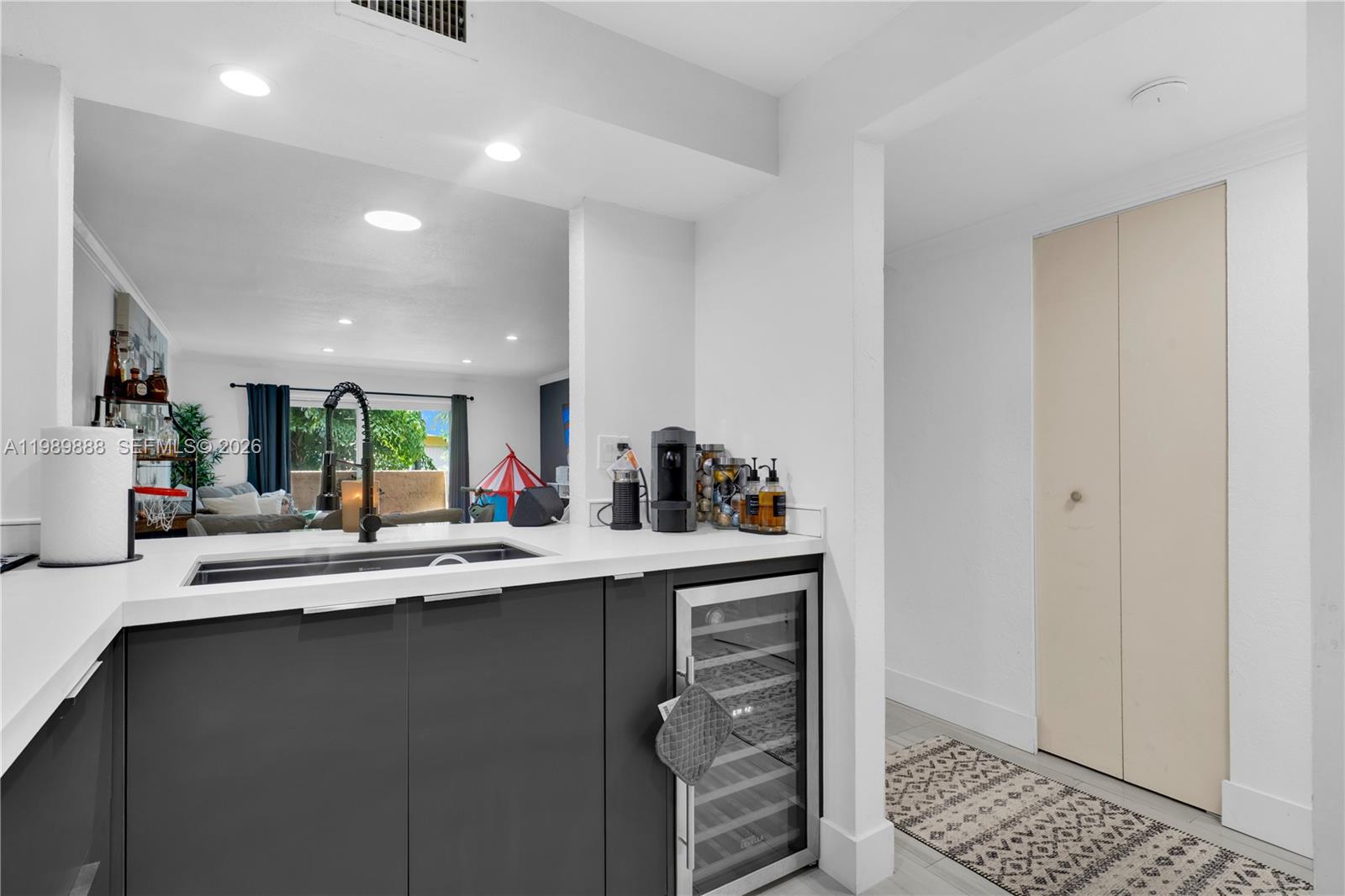 A modern kitchen features dark gray cabinets, a wine cooler, and a white countertop — 9956 SW 88th St # 1, Miami FL 33176, MIAMI, FL