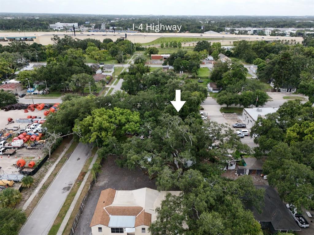 An aerial view shows a residential lot with mature trees near the I-4 highway — 1413 29TH STREET, ORLANDO, FL