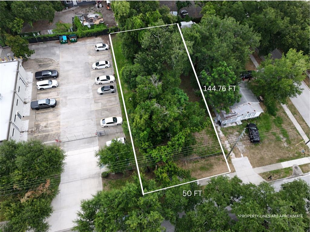 An aerial view shows a rectangular, tree-covered vacant lot outlined in white — 1413 29TH STREET, ORLANDO, FL