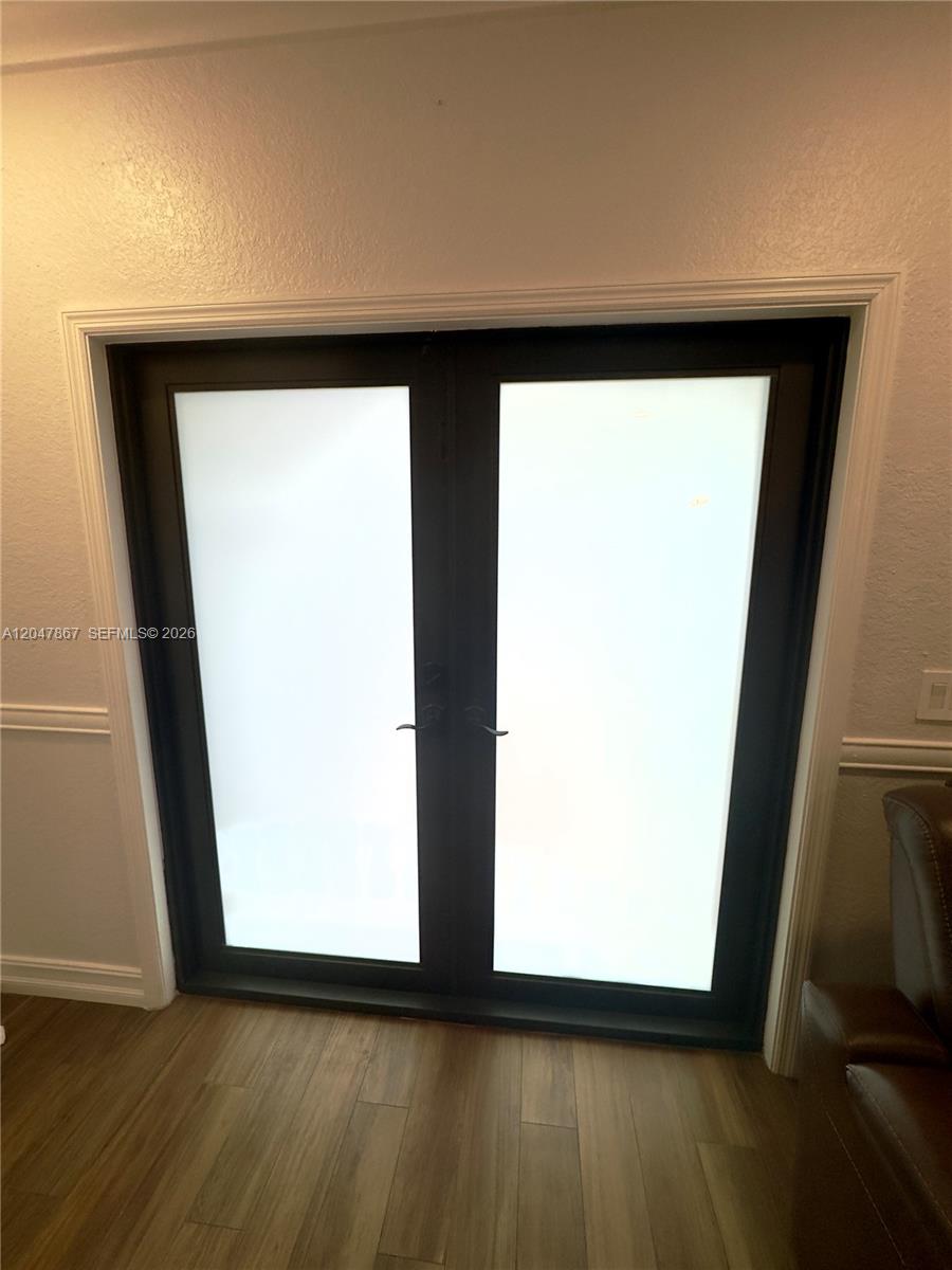 A set of black-framed French doors with frosted glass panels is set into a wall — 17833 SW 155th Ct # 0, Miami FL 33187, MIAMI, FL
