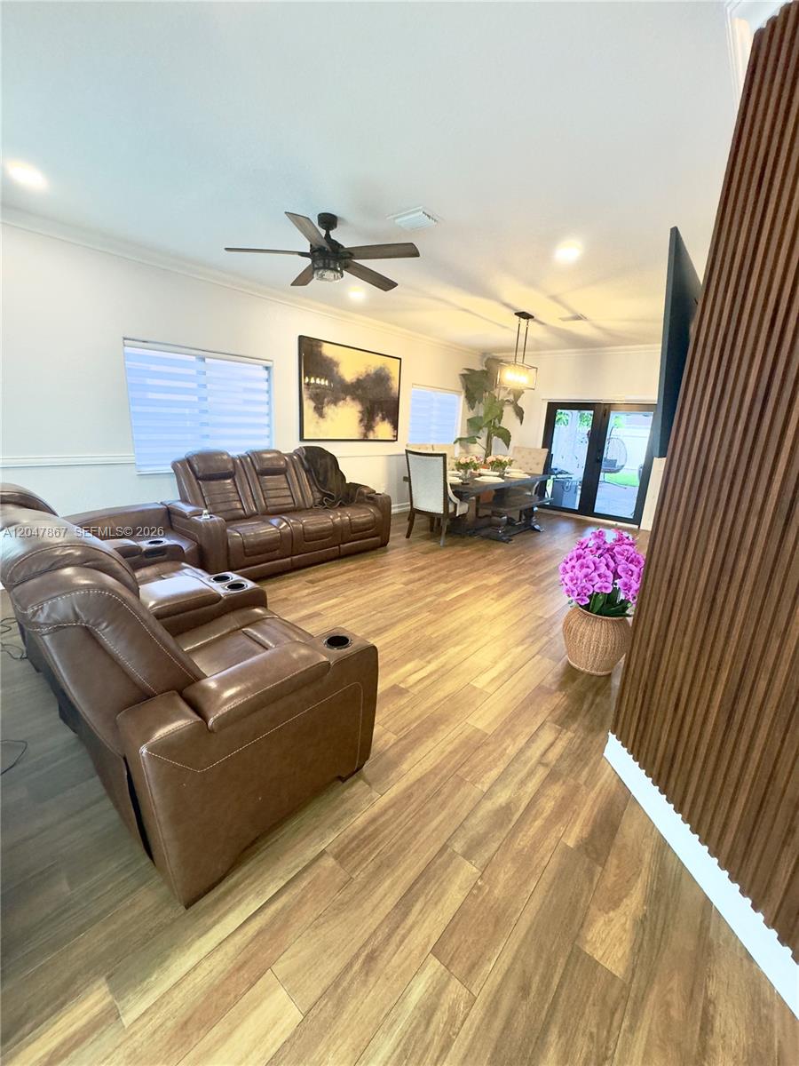 A living and dining area features brown leather recliners, wood-look flooring, and a dining set — 17833 SW 155th Ct # 0, Miami FL 33187, MIAMI, FL