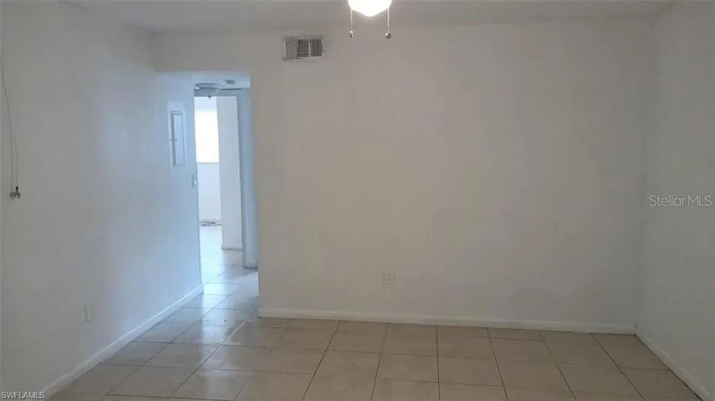 An empty room with white walls, a ceiling fan, and light-colored tile flooring — 2524 CONGRESS STREET UNIT #4, FORT MYERS, FL