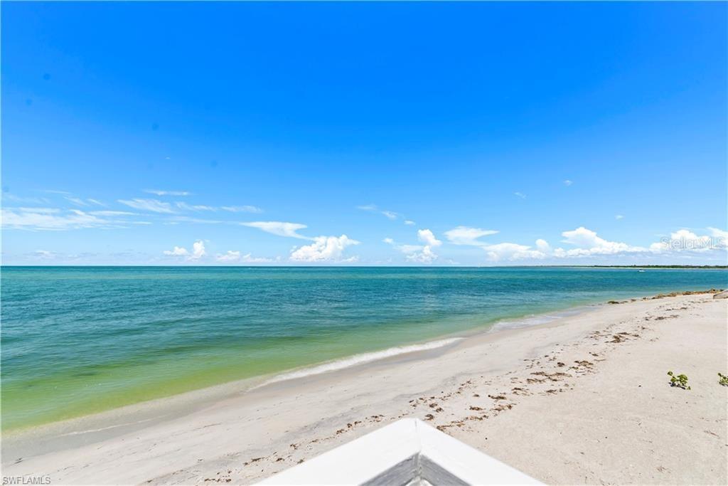 A view of a sandy beach and the ocean from an elevated deck — 4621 ORO PESOS LANE, CAPTIVA, FL