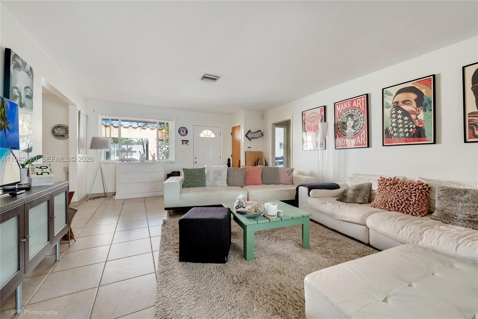 A living room features white sofas, a green coffee table, tile floors, and wall art — 5700 SW 45th Ter, Miami FL 33155, MIAMI, FL