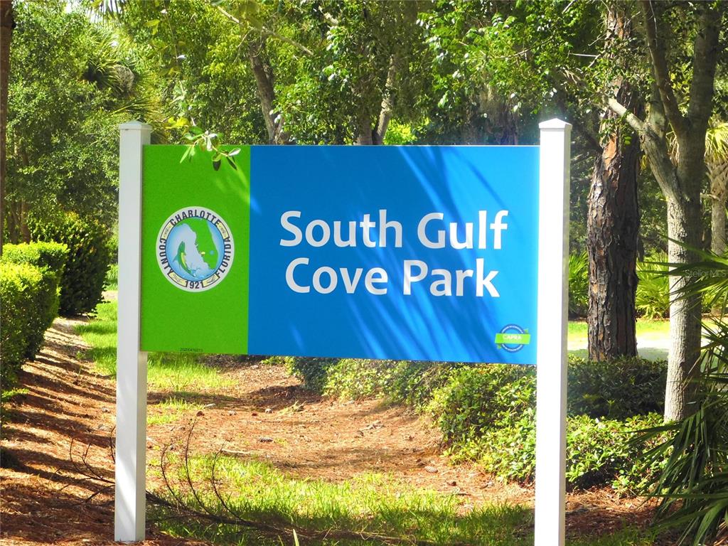 A sign for South Gulf Cove Park stands in a wooded area — 16207 RENNIE ROAD, PORT CHARLOTTE, FL