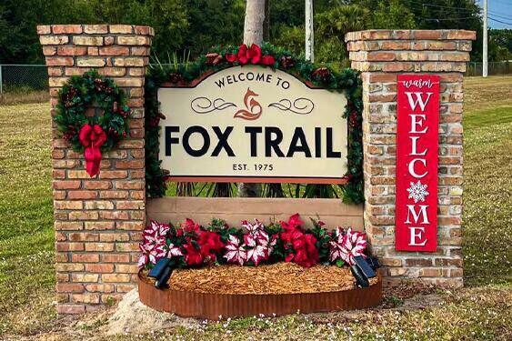 A brick entrance sign for Fox Trail decorated with a wreath, poinsettias, and a welcome sign — 1340 Arabian Drive, Loxahatchee FL 33470, LOXAHATCHEE, FL