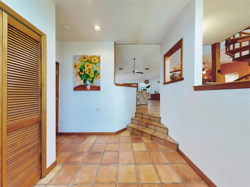 A tiled entryway features a set of steps leading up to an open living area — 1205 WILLIAMS ROAD, NEW SMYRNA BEACH, FL