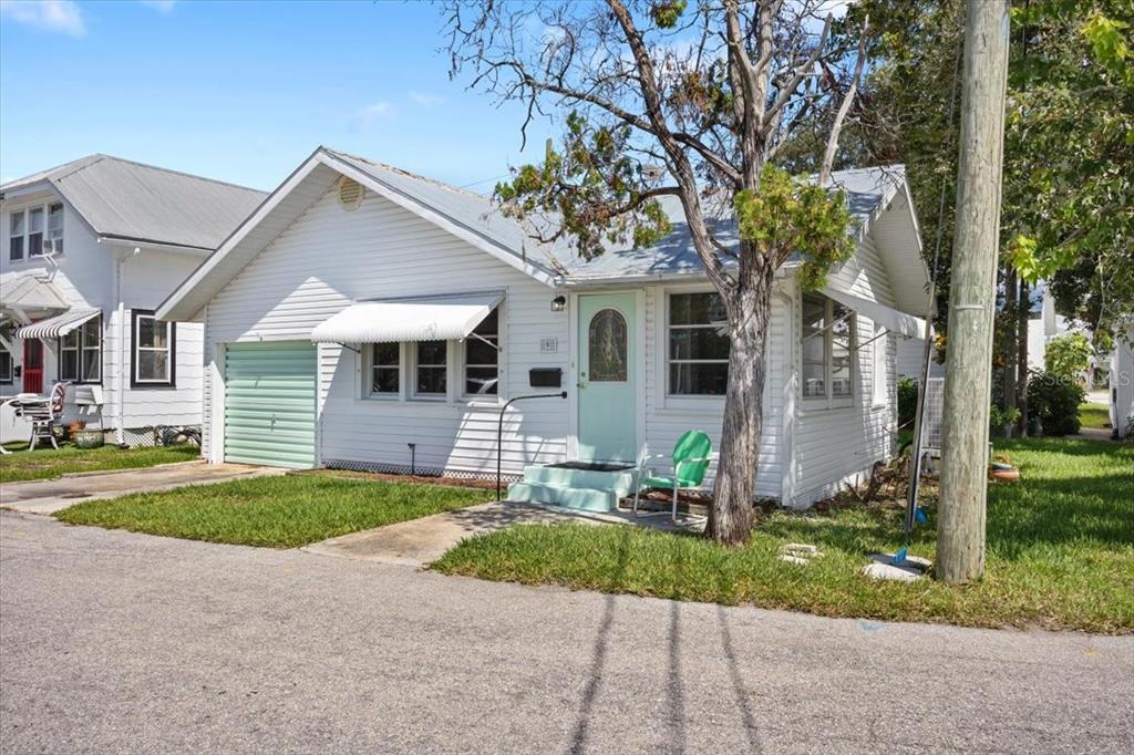 A white, single-story house with a mint green door, garage door, and front steps — 9 SEMINOLE DRIVE, BRADENTON, FL