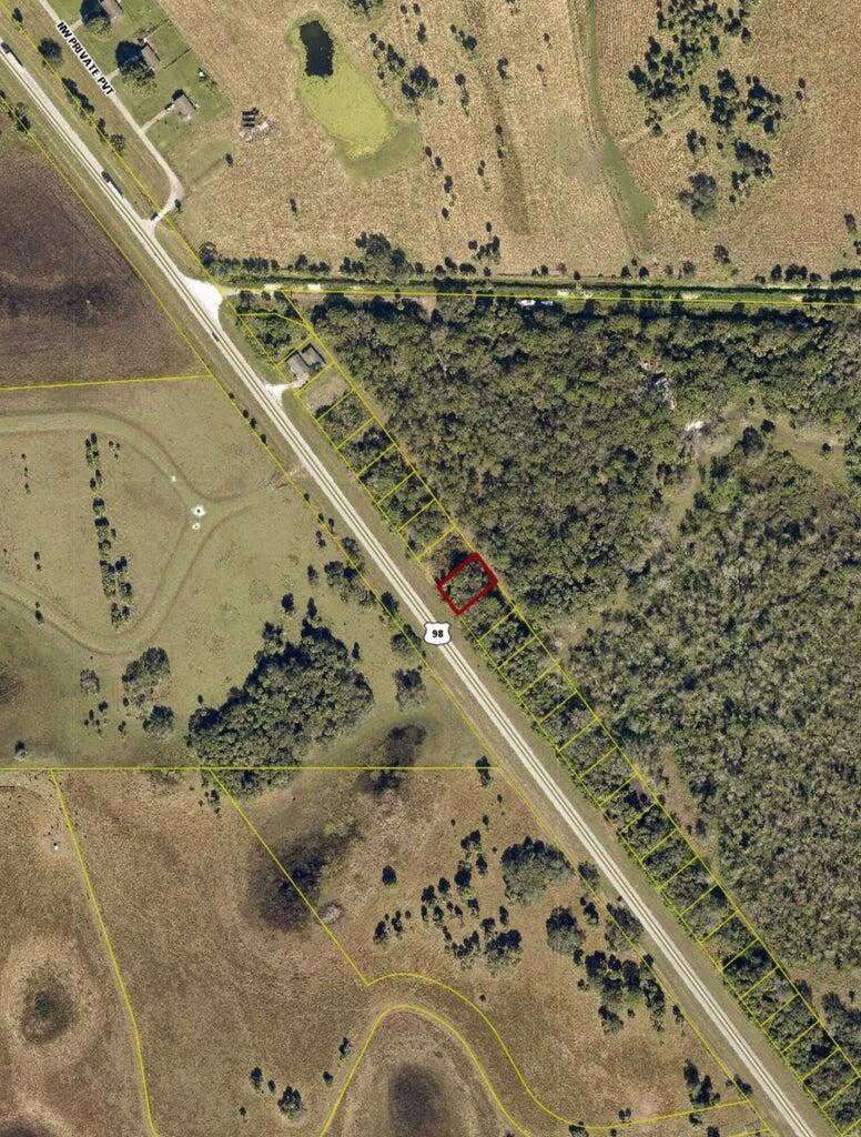 An aerial map shows a rectangular parcel of land highlighted in red along a highway — 3822 Hwy 98 N, Okeechobee FL 34972, OKEECHOBEE, FL